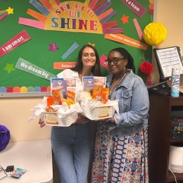 two women holding gift baskets