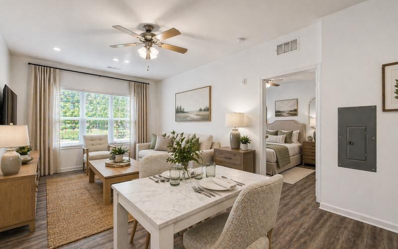 a living room with a large chandelier and a table
